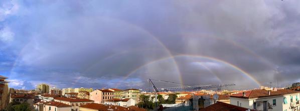 A composite showing four rainbows. Each is centred on different points