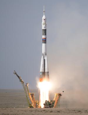 A Soyuz rocket clears the launch tower, taking a crewed Soyuz spaceship to the ISS.