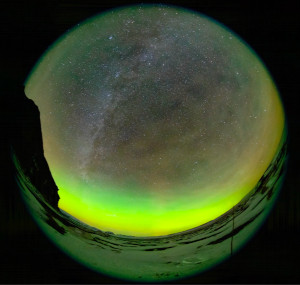 The sky rotates around one star that appears fixed. Bubbles and swirls of green aurorae fill the foreground