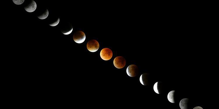 A composite of images of the Moon. Along the sequence of images, the Moon's colour changes from grey to red and back to grey.