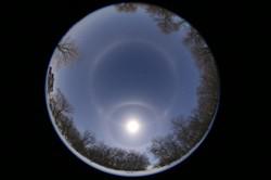 All sky image showing the Moon at the lower center surrounded by a bright ring with another, fainter ring in the image centre