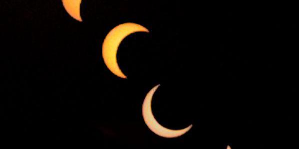 Six images of the Sun. The moon moves across the Sun’s disk, covering most in the middle images before moving away.