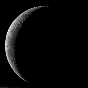 Most of the moon is dark, but a thin crescent on the left is light