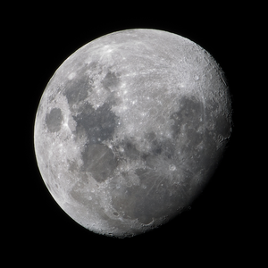 The Moon is mostly illuminated but a thin crescent on the right side of the Moon is in darkness